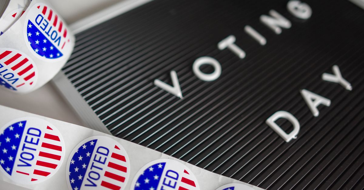 I Voted stickers with an American flag design and Voting Day sign symbolize U.S. electoral participation.